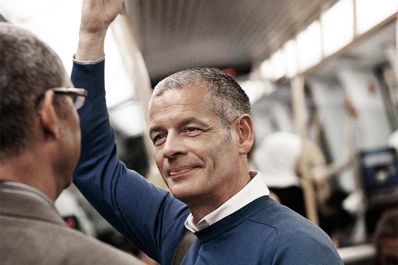 man wearing hearing aids in train station